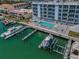 Aerial view showing condo complex, pool, and boat docks at 415 Island Way # 511, Clearwater Beach, FL 33767