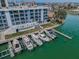 Aerial shot of a condo building with a pool and boat docks, showcasing waterfront living and amenities at 415 Island Way # 511, Clearwater Beach, FL 33767