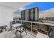 Condo balcony with outdoor seating, glass railings, and beautiful city views at 415 Island Way # 511, Clearwater Beach, FL 33767