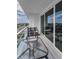 Condo balcony with glass railings and outdoor furniture with city views at 415 Island Way # 511, Clearwater Beach, FL 33767