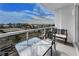 Balcony with glass railings and outdoor furniture overlooking the city and harbor at 415 Island Way # 511, Clearwater Beach, FL 33767
