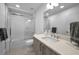 Bright bathroom with white subway tile shower and modern vanity with stone countertop and neutral tones at 415 Island Way # 511, Clearwater Beach, FL 33767