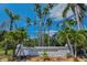 Island Estates sign with palm trees, landscaping, and a blue sky in the background at 415 Island Way # 511, Clearwater Beach, FL 33767