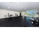 Well-equipped gym with various machines, rubber flooring, bright lighting, and outside views at 415 Island Way # 511, Clearwater Beach, FL 33767