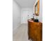 Hallway with wood cabinet, mirror, lamp and tile floor at 415 Island Way # 511, Clearwater Beach, FL 33767