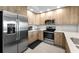 Modern kitchen features stainless steel appliances and light wood cabinetry at 415 Island Way # 511, Clearwater Beach, FL 33767