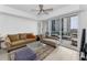 Cozy living room with comfortable seating, an open balcony, and lots of natural light at 415 Island Way # 511, Clearwater Beach, FL 33767