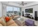 Bright living room features modern decor, balcony access, and city views at 415 Island Way # 511, Clearwater Beach, FL 33767