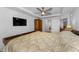 Cozy bedroom featuring a ceiling fan and an ensuite bath with modern flooring and decor at 415 Island Way # 511, Clearwater Beach, FL 33767