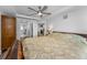 Bedroom showcasing modern ceiling fan, ensuite bath and modern wood flooring at 415 Island Way # 511, Clearwater Beach, FL 33767