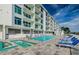 Community pool with ample lounge chairs, community hot tub, and an open and airy feel at 415 Island Way # 511, Clearwater Beach, FL 33767