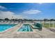 Community pool area with hot tub, lounge chairs, and beautiful waterfront views on a sunny day at 415 Island Way # 511, Clearwater Beach, FL 33767