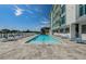A community pool area with lounge chairs offers a tranquil waterfront retreat for residents at 415 Island Way # 511, Clearwater Beach, FL 33767