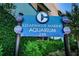 Clearwater Marine Aquarium sign surrounded by lush greenery at 415 Island Way # 511, Clearwater Beach, FL 33767