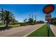 Street view of a trolley stop with informative signage and clear blue skies at 415 Island Way # 511, Clearwater Beach, FL 33767