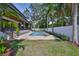 Green backyard with a private pool and patio with a manicured lawn and landscaping at 4224 W Corona St, Tampa, FL 33629
