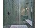 Shower room featuring sleek green tiles, glass enclosure, and integrated shower bench at 4224 W Corona St, Tampa, FL 33629