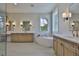 Bright bathroom featuring double vanities, soaking tub, and elegant fixtures at 4224 W Corona St, Tampa, FL 33629