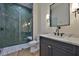 Chic bathroom featuring glass-enclosed shower with green tile and a vanity with a marble countertop at 4224 W Corona St, Tampa, FL 33629