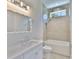 Clean bathroom with white fixtures and a combination tub/shower at 4224 W Corona St, Tampa, FL 33629