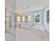 Luxurious bathroom featuring a soaking tub, walk-in shower, dual vanities, and large windows for natural light at 4224 W Corona St, Tampa, FL 33629