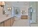 Bright bathroom featuring double vanities, soaking tub, and walk-in glass shower at 4224 W Corona St, Tampa, FL 33629
