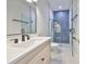 Stylish bathroom featuring a walk-in shower with blue tiled wall, modern vanity, and sleek fixtures at 4224 W Corona St, Tampa, FL 33629