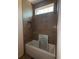 Bathroom area featuring a tub under a window with custom tile at 4224 W Corona St, Tampa, FL 33629