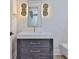 Bathroom featuring vanity with mirror, sconces, drawers and marble countertop at 4224 W Corona St, Tampa, FL 33629