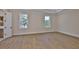 Spacious bedroom featuring hardwood floors, white trim, and two large windows at 4224 W Corona St, Tampa, FL 33629