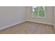 Bright bedroom features wood-look floors, a double window, and neutral paint, creating a relaxing and inviting space at 4224 W Corona St, Tampa, FL 33629