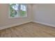 Bright bedroom features wood-look floors, a double window, and neutral paint, creating a relaxing and inviting space at 4224 W Corona St, Tampa, FL 33629