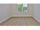 Bright bedroom offers wood-look floors, a large window, and neutral paint, creating a peaceful retreat at 4224 W Corona St, Tampa, FL 33629