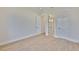 Bright bedroom with light wood floors, white trim, and doors leading to a closet or ensuite bathroom at 4224 W Corona St, Tampa, FL 33629