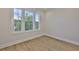 Bright bedroom offers wood-look floors, a large window, and neutral paint, creating a peaceful retreat at 4224 W Corona St, Tampa, FL 33629