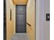 A convenient elevator with a stylish herringbone floor and a black metal gate provides easy access to different levels of the home at 4224 W Corona St, Tampa, FL 33629