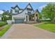 Stunning two-story home with a stone-accented porch, brick driveway, and gray accents at 4224 W Corona St, Tampa, FL 33629