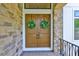 Charming double front doors with stone surround and green wreaths at 4224 W Corona St, Tampa, FL 33629