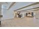 Spacious great room with wood beam ceilings, open staircase, and kitchen area at 4224 W Corona St, Tampa, FL 33629