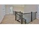 Second floor hallway with hardwood floors and iron railing at 4224 W Corona St, Tampa, FL 33629