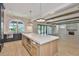 Modern kitchen featuring stone accent wall, oversized island and open concept to the living space at 4224 W Corona St, Tampa, FL 33629