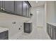 Well-equipped laundry room with modern cabinets, fixtures, and stylish flooring at 4224 W Corona St, Tampa, FL 33629