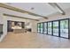 Expansive living room featuring wood beams, and sliding glass doors, creating an airy and light-filled space for entertaining at 4224 W Corona St, Tampa, FL 33629