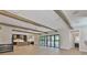 Bright open-concept living space with wood beams, large doors, and kitchen at 4224 W Corona St, Tampa, FL 33629