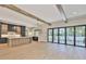 Bright open-concept living space with wood beams, large doors, and kitchen at 4224 W Corona St, Tampa, FL 33629