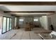 Bright, unfinished living room featuring exposed wooden beams and a stone fireplace at 4224 W Corona St, Tampa, FL 33629