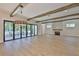 A grand living room boasting wood beams, a stone fireplace, and sliding glass doors leading to an outdoor space at 4224 W Corona St, Tampa, FL 33629