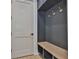Mud room features custom storage, bench seating and coat hooks near an entry door at 4224 W Corona St, Tampa, FL 33629