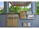 Close up of outdoor kitchen grill station with stainless steel appliances and exhaust hood at 4224 W Corona St, Tampa, FL 33629