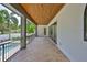 Covered patio offering an outdoor space with wood ceilings, pool views, and sliding glass doors at 4224 W Corona St, Tampa, FL 33629